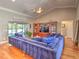 Spacious living room features hardwood floors, large plush sofa, built-in entertainment center, and access to the outdoor area at 2410 Se 23Rd Pl, Ocala, FL 34471