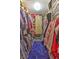 Large walk-in closet with custom shelving, hanging racks, and a built-in shoe rack and vanity at 2410 Se 23Rd Pl, Ocala, FL 34471