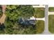 Overhead shot of the house showing mature trees, lawn, driveway, and relationship to street and neighborhood at 2515 Se 77Th St, Ocala, FL 34480