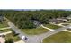 Stunning aerial view of the property, showcasing the landscaped yard and neighborhood surrounded by lush greenery at 2515 Se 77Th St, Ocala, FL 34480