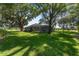 Expansive backyard featuring a well-maintained lawn, mature trees, and a screened pool enclosure, great for outdoor enjoyment at 2515 Se 77Th St, Ocala, FL 34480