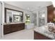Luxurious bathroom featuring a soaking tub, walk-in shower, and granite countertops at 2515 Se 77Th St, Ocala, FL 34480