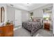 Cozy bedroom with a metal frame bed, two windows, and two bedside tables at 2515 Se 77Th St, Ocala, FL 34480