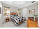 Comfortable bedroom featuring a checkered comforter, warm lighting, and natural wood furniture at 2515 Se 77Th St, Ocala, FL 34480