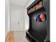 Hallway with decorative coat rack, storage baskets, and a rustic wooden bench at 2515 Se 77Th St, Ocala, FL 34480