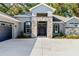 Inviting front entrance with stone accents, a modern door with wreath, and manicured shrubs for added curb appeal at 2515 Se 77Th St, Ocala, FL 34480