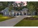 Charming home featuring a manicured lawn, stone accents, a two-car garage, and a welcoming front entrance at 2515 Se 77Th St, Ocala, FL 34480