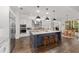 Open kitchen with a large island, pendant lighting, and modern stainless steel appliances at 2515 Se 77Th St, Ocala, FL 34480