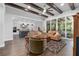 Bright living room showcasing beamed ceilings, hardwood floors, an open-concept design, and views of the pool area at 2515 Se 77Th St, Ocala, FL 34480