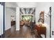 Open-concept living room with wood floors, wood beam ceilings, and seamless flow to the kitchen and outdoor spaces at 2515 Se 77Th St, Ocala, FL 34480