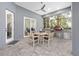 Covered patio area featuring an outdoor dining set and a summer kitchen with built-in pizza oven at 2515 Se 77Th St, Ocala, FL 34480