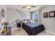 Comfortable bedroom with modern decor, ample lighting, and a window view of the neighborhood at 2864 Ne 21St Court Rd, Ocala, FL 34470
