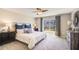 Serene bedroom with soft lighting, a comfortable bed, and a view of the backyard at 2864 Ne 21St Court Rd, Ocala, FL 34470