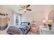 Bright bedroom with a ceiling fan, stylish decor, and a comfortable bed, creating a cozy and inviting space at 2864 Ne 21St Court Rd, Ocala, FL 34470