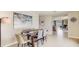 Cozy dining area with seating for four, an abstract painting, and seamless flow into the living space at 2864 Ne 21St Court Rd, Ocala, FL 34470