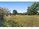 Large grassy backyard with trees and a swimming pool, perfect for outdoor recreation and relaxation at 4083 Se 38Th Loop, Ocala, FL 34480