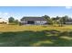 Expansive backyard featuring a fenced pool area, lush green lawn, and a view of the home's rear elevation at 4083 Se 38Th Loop, Ocala, FL 34480
