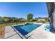 A beautiful backyard features a pristine pool surrounded by a fence, lush greenery, and comfortable outdoor seating at 4083 Se 38Th Loop, Ocala, FL 34480