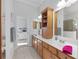 Bathroom boasts dual sinks, and ample cabinet space, with view to the adjacent bedroom at 4083 Se 38Th Loop, Ocala, FL 34480