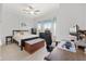 Comfortable bedroom with a bay window, ceiling fan, and dedicated desk area at 4083 Se 38Th Loop, Ocala, FL 34480