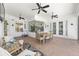 Large, covered patio with ample seating, ceiling fans, access to the backyard, and a peek into interior spaces at 4083 Se 38Th Loop, Ocala, FL 34480