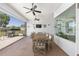 Spacious covered patio with ceiling fans, outdoor dining set, grill, and view of the backyard at 4083 Se 38Th Loop, Ocala, FL 34480