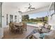 Relaxing covered patio with dining area, lounge chairs, and a view of the pool and fenced backyard at 4083 Se 38Th Loop, Ocala, FL 34480