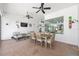Inviting covered patio featuring a dining area, lounge seating, ceiling fans, and outdoor decor at 4083 Se 38Th Loop, Ocala, FL 34480