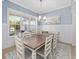 Bright dining room with wainscoting, modern chandelier, and large window at 4083 Se 38Th Loop, Ocala, FL 34480