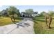 Elegant home with a circular driveway, lush landscaping, and a charming facade at 4083 Se 38Th Loop, Ocala, FL 34480
