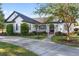 Charming single-story home boasts a meticulously landscaped yard and inviting curb appeal, enhanced by a well-lit walkway at 4083 Se 38Th Loop, Ocala, FL 34480