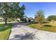 Inviting home showcasing a long driveway, lush lawn, and well-placed palm trees, creating curb appeal at 4083 Se 38Th Loop, Ocala, FL 34480