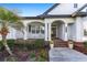 Inviting front porch with brick flooring, white railings, rocking chairs, and a warm welcome wreath on the front door at 4083 Se 38Th Loop, Ocala, FL 34480