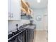Well-lit laundry room featuring modern washer and dryer, cabinetry, shelving, and stylish tile backsplash at 4083 Se 38Th Loop, Ocala, FL 34480