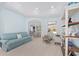 A cozy living room features a light blue sofa, chairs, and decorative shelving at 4083 Se 38Th Loop, Ocala, FL 34480