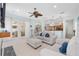 Bright living room with plush seating, ceiling fan, and seamless flow to the kitchen and dining area at 4083 Se 38Th Loop, Ocala, FL 34480