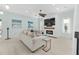 Cozy living room with fireplace, ceiling fan, and large-screen TV, perfect for relaxing at 4083 Se 38Th Loop, Ocala, FL 34480