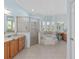 Main bathroom with a walk-in shower, soaking tub, and dual vanity at 4083 Se 38Th Loop, Ocala, FL 34480