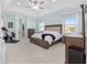 Spacious main bedroom with tray ceiling, neutral colors, and en-suite bath at 4083 Se 38Th Loop, Ocala, FL 34480