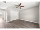Bright bedroom featuring wood-look floors and closet with bi-fold doors at 46 Guava Pass Terrace, Ocklawaha, FL 32179