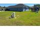Spacious backyard with green grass and outdoor equipment at 4770 Sw 114Th St, Ocala, FL 34476