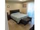 Neutral toned bedroom boasts a large bed, bench and sliding glass doors to let in plenty of light at 4770 Sw 114Th St, Ocala, FL 34476