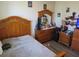 Bedroom with hardwood floors features a wooden bed frame with matching dresser and mirror at 4770 Sw 114Th St, Ocala, FL 34476