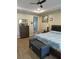 Spacious bedroom with tray ceiling, wood floors, dresser and comfortable furnishings, creating a relaxing retreat at 4770 Sw 114Th St, Ocala, FL 34476