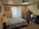 Bedroom with ceiling fan features a large window, dresser, and ample storage with neutral tones at 4770 Sw 114Th St, Ocala, FL 34476
