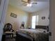 Comfortable bedroom features a ceiling fan, window, and hardwood floors at 4770 Sw 114Th St, Ocala, FL 34476