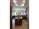Open concept kitchen featuring dark cabinets, island, and tiled flooring at 4770 Sw 114Th St, Ocala, FL 34476