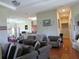 Spacious open living room with hardwood floors features multiple seating areas with good flow and plenty of light at 4770 Sw 114Th St, Ocala, FL 34476