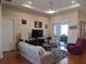 Cozy living room features a plush rug, comfortable seating, and access to the outdoor area at 4770 Sw 114Th St, Ocala, FL 34476