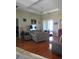 Spacious living room with hardwood floors, comfortable seating, and sliding-door access at 4770 Sw 114Th St, Ocala, FL 34476